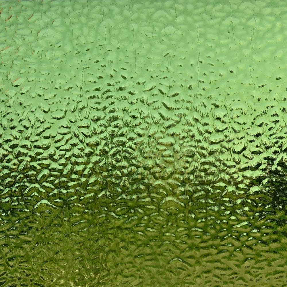 Textured green glass with a bubbled, hammered surface pattern.