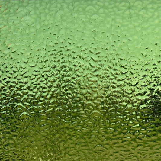 Textured green glass with a bubbled, hammered surface pattern.