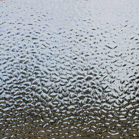 Textured clear glass with a wavy, hammered pattern, shown close-up.