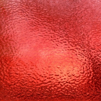Red textured glass with a hammered or bubbly pattern and a glossy finish.