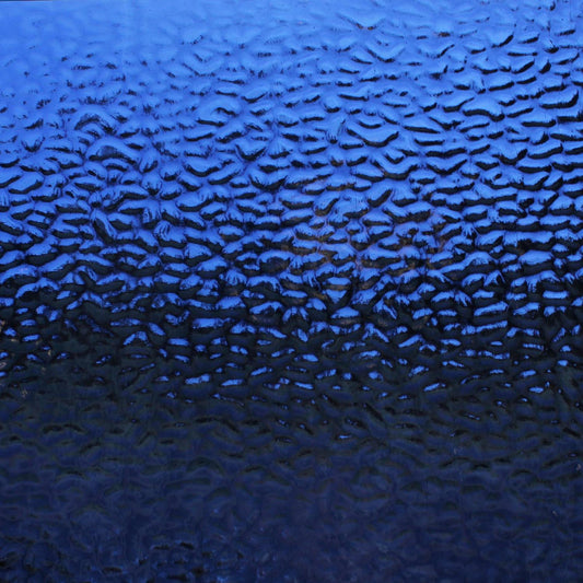A close-up of a blue textured surface with a repeating wavy pattern, filling the entire frame.
