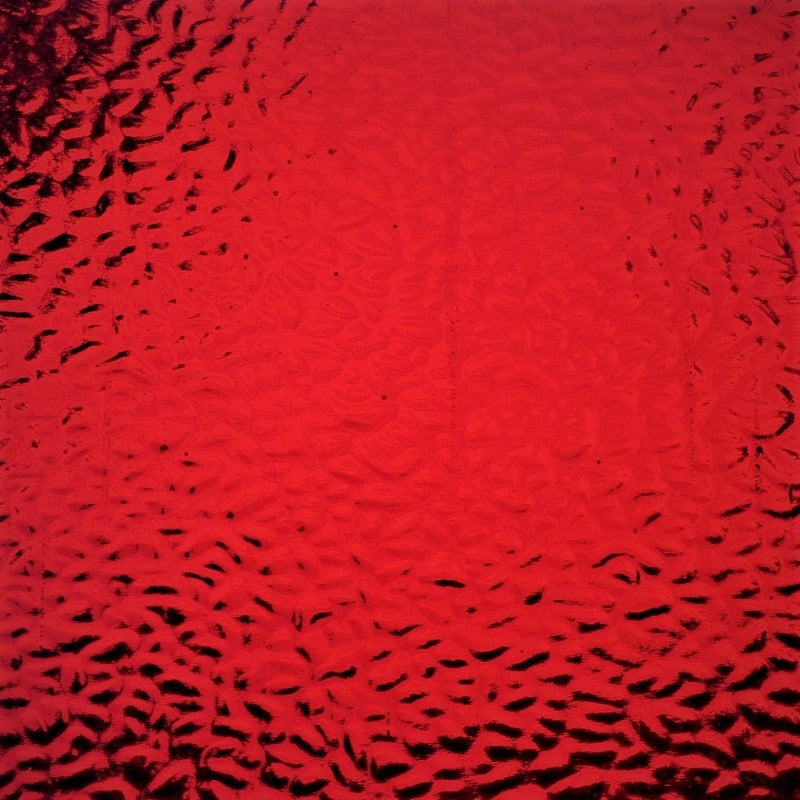 Red textured glass with a hammered or bubbled pattern, showing dark reflections.