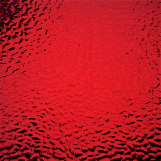 Red textured glass with a hammered or bubbled pattern, showing dark reflections.