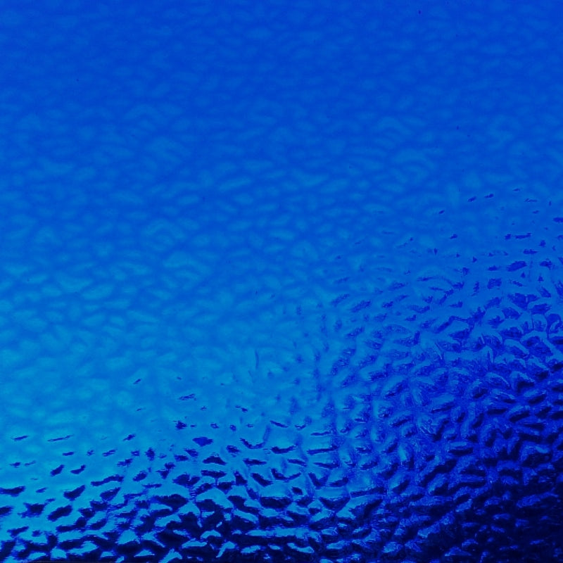 A close-up of a textured blue surface with a subtle pebble or frosted pattern, filling the entire frame.