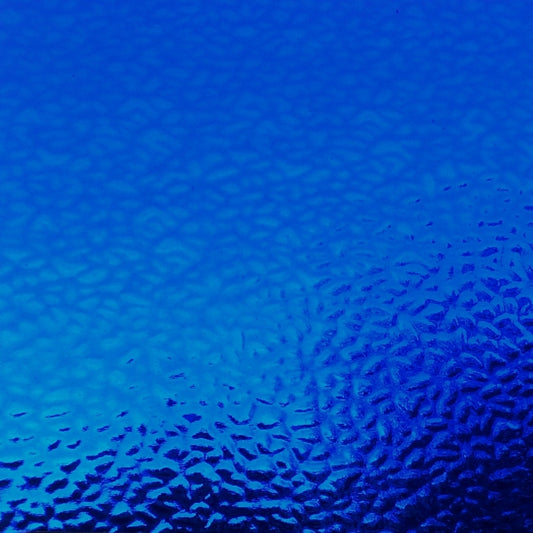 A close-up of a textured blue surface with a subtle pebble or frosted pattern, filling the entire frame.