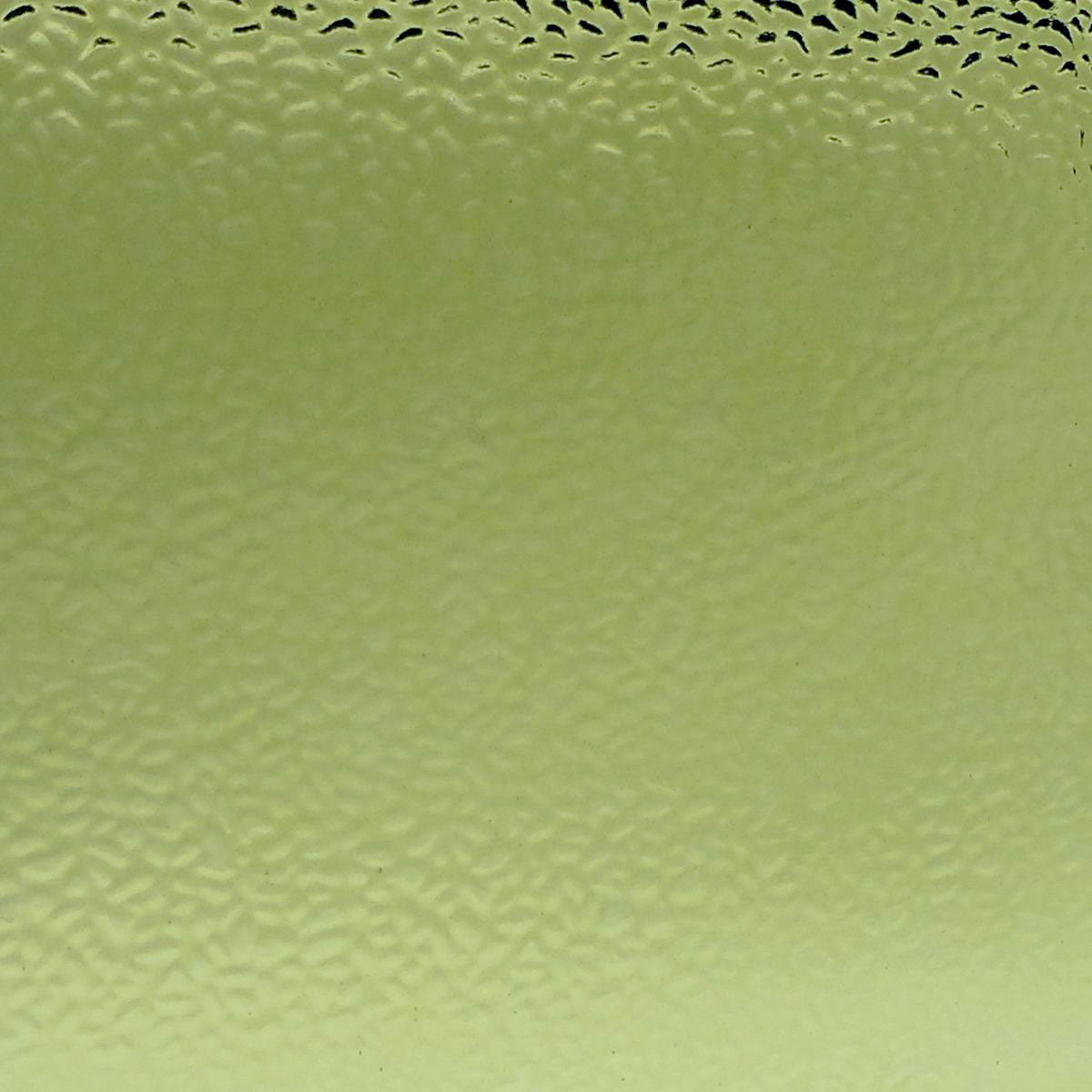 A close-up of a pale yellow-green textured material with a subtle honeycomb or bubble-like pattern across the surface.