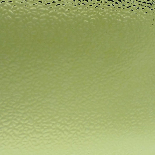 A close-up of a pale yellow-green textured material with a subtle honeycomb or bubble-like pattern across the surface.