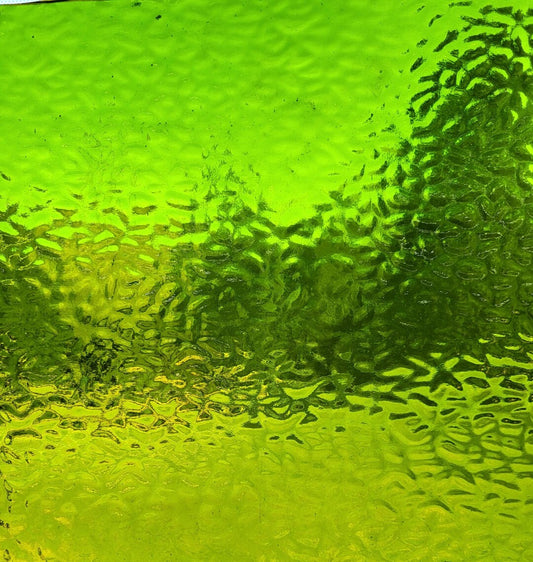 Bright lime green textured glass with a hammered or bubbled surface pattern.
